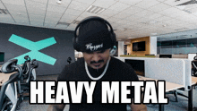 a man wearing headphones and a beanie with the word heavy metal written on it
