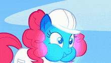 a blue and pink pony with a white hat