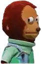 a stuffed monkey wearing a green shirt and overalls .
