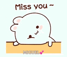 a cartoon seal with the words `` miss you '' written on it .
