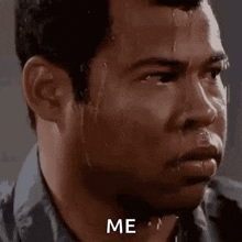 a man with sweat running down his face is looking at the camera with the words `` me '' written on his face .