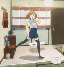 a girl in a striped shirt and shorts is dancing in a room