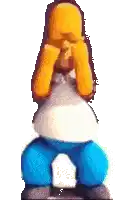 homer simpson is covering his eyes with his hands while sitting on a block .