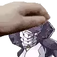 a close up of a person 's hand holding a cartoon character 's head .