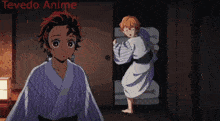 a boy in a kimono is standing next to a girl in a room .