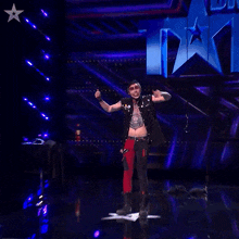 a man with a skull tattoo on his chest says ta-da!