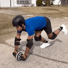 a man wearing a helmet and knee pads is playing with a skateboard