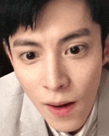 a close up of a man 's face making a funny face