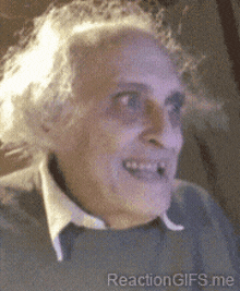 a close up of an elderly man 's face with a reaction gifs.me watermark