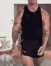 a man with a lot of tattoos on his arms and chest