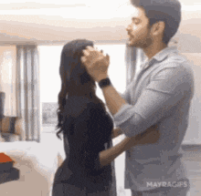a man is putting makeup on a woman 's face .