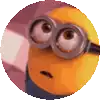 a close up of a yellow minion wearing glasses and making a surprised face .