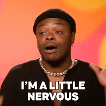 a man with a beanie and a necklace says i 'm a little nervous