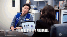 a man with a name tag that says jonah sits at a desk with a laptop