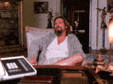 a man is sitting in a chair with his legs crossed