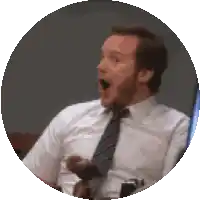 a man in a white shirt and tie with his mouth open