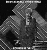 a black and white photo of a woman with the caption surprise surprise meme ( slowed )