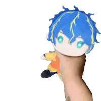 a person is holding a stuffed animal with blue hair and green eyes