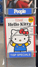a hello kitty magazine is displayed on a shelf with other magazines