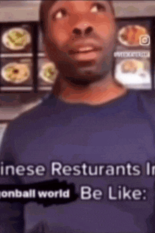 a man in a blue shirt is standing in front of a display of food .
